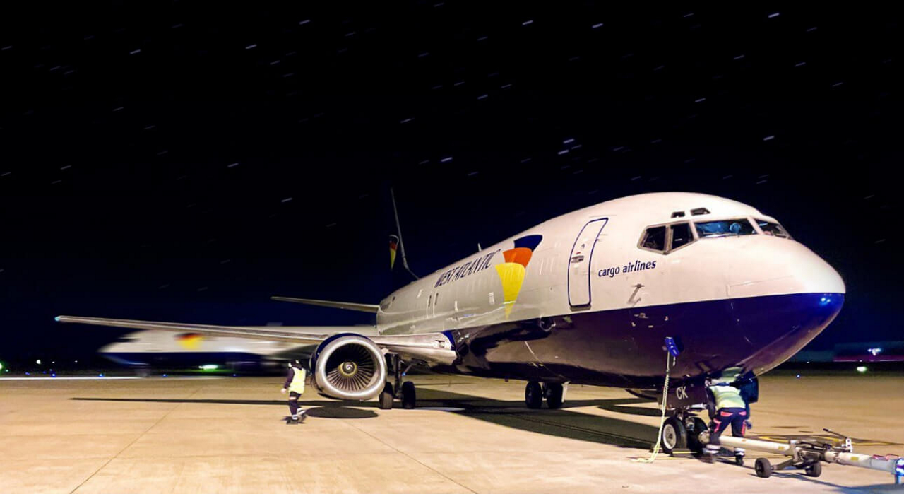 West Atlantic cargo aircraft on the tarmac, symbolizing enhanced global connectivity with Three Business's 5G network.